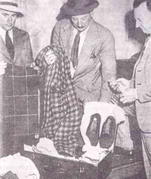 Detectives examine the dead man’s suitcase